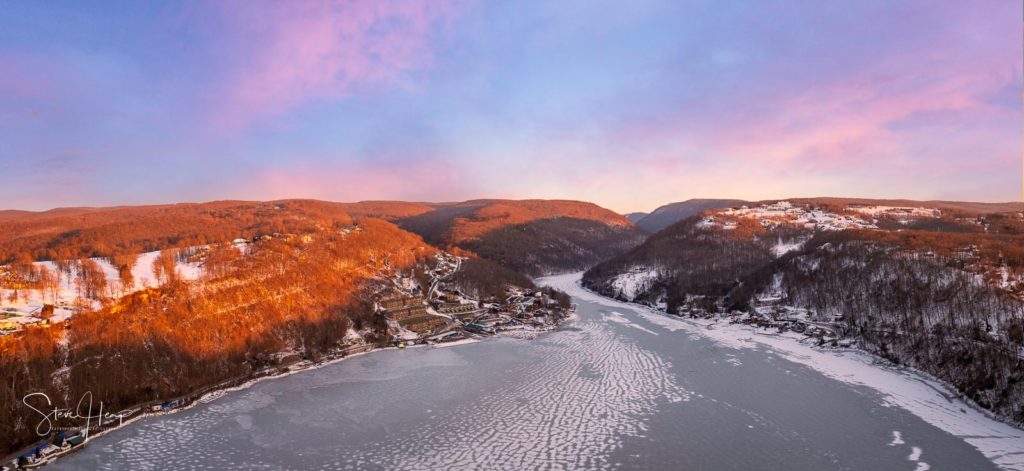 Wall art of the sun setting over the snow covered Cheat Lake near Morgantown West Virginia