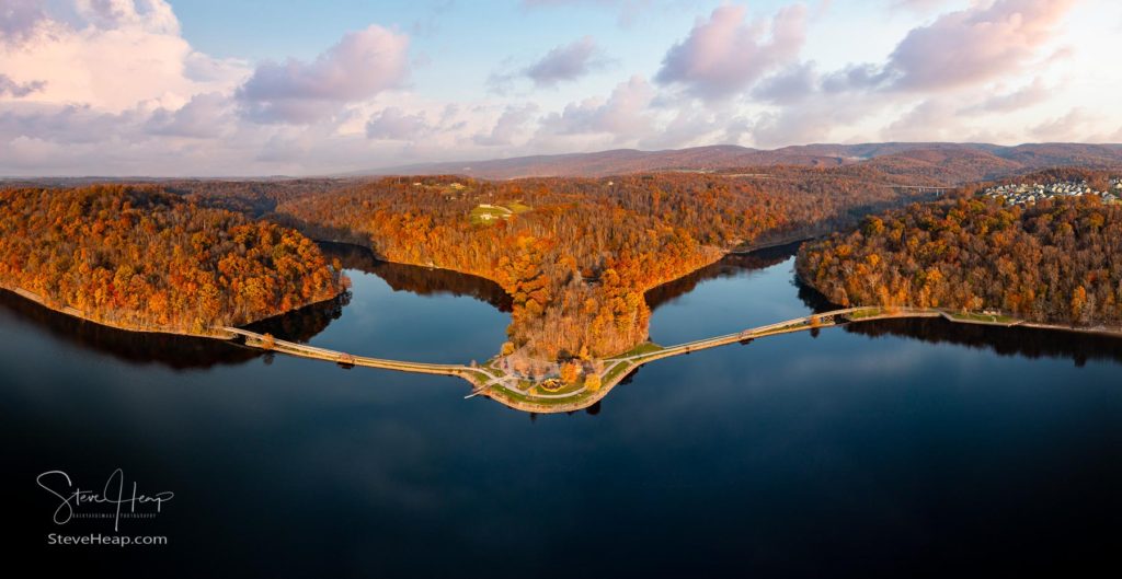 Sun setting casts warm light on the park at Cheat Lake near Morgantown West Virginia on a beautiful calm autumn day. 