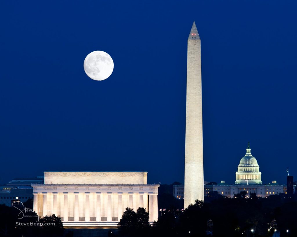 From almost the same location as the Iwo Jima Statue is this classic view of the DC monuments with a full Harvest moon rising above the Lincoln Memorial with Washington Monument and Capitol building aligned