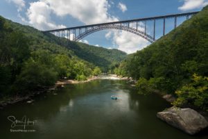 Rafters float towards the rapids under the high arched New River Gorge bridge in West Virginia. What I like about this image in particular is the subtle lighting. It is generally quite dark although the destination (the rapids) are more brightly lit with the sun, and the raft in blue is quite sharp and clear (of course that got a little extra work in Lightroom!)