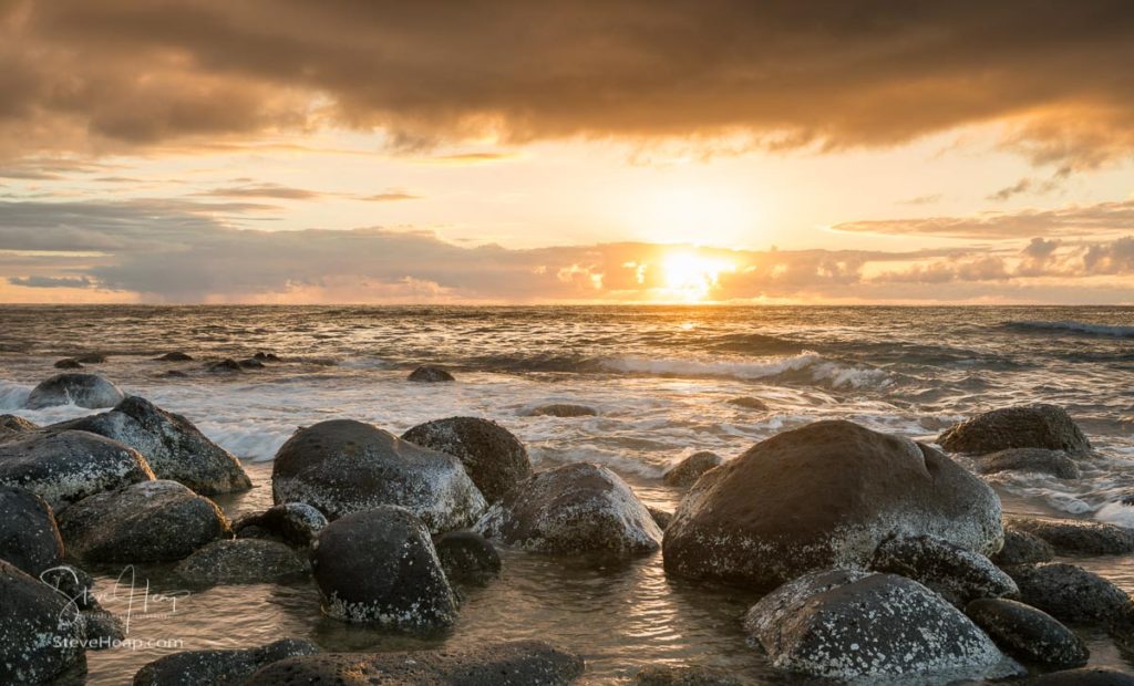 Sun setting over the Pacific Ocean and worn rocks from Ke'e Beach on north of Kauai, Hawaii. Prints available here in my online store