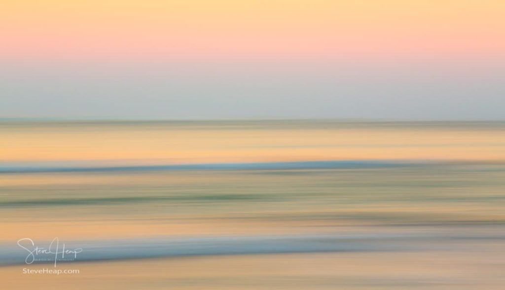 Sideways panning across the ocean reflecting the soft light of sunrise in Hawaii at Hanelei Bay. Prints in my online store