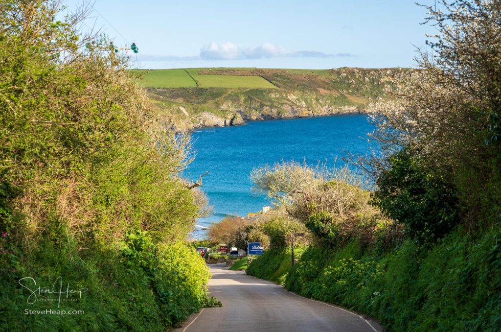 Carne Beach, Cornwall, UK - 18 April 2022: Narrow lane to The Nare Hotel at Carne Beach in Cornwall