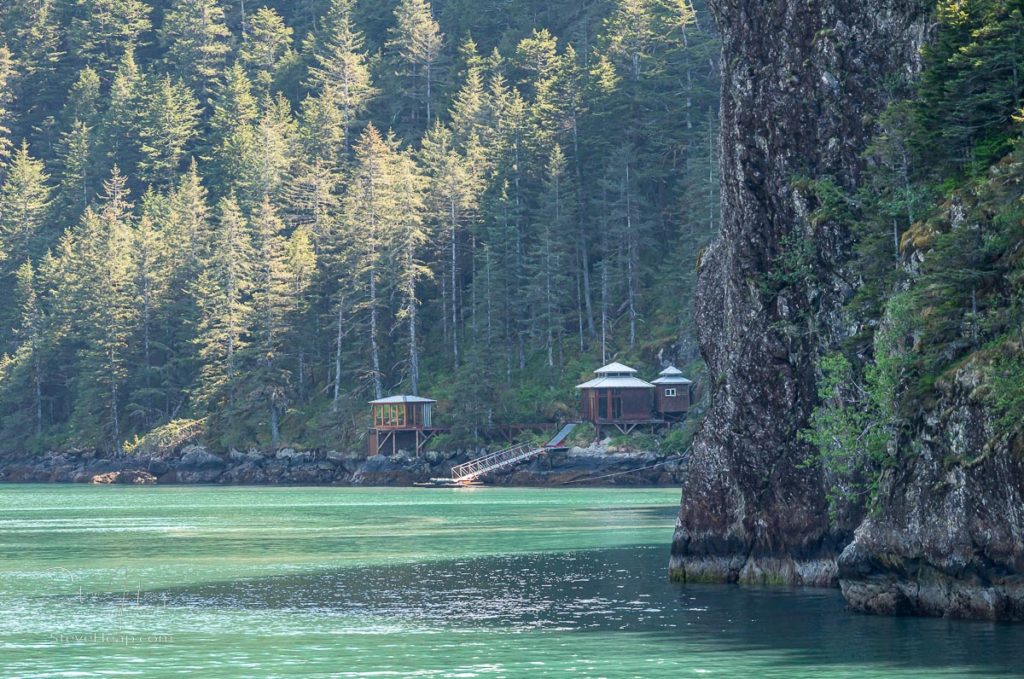 Small modern wooden cabins on the shore of Resurrection Bay near Seward Alaska
