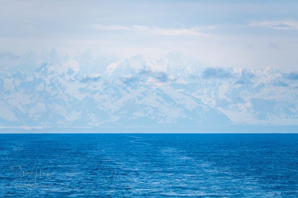 Mysterious looking image of the Alaskan mountains disappearing in the mists as we sail away