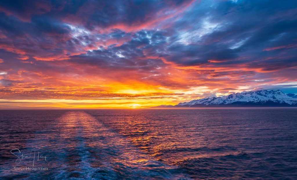 Sailing away from the sunset and away from the mountains of the Alaska coast
