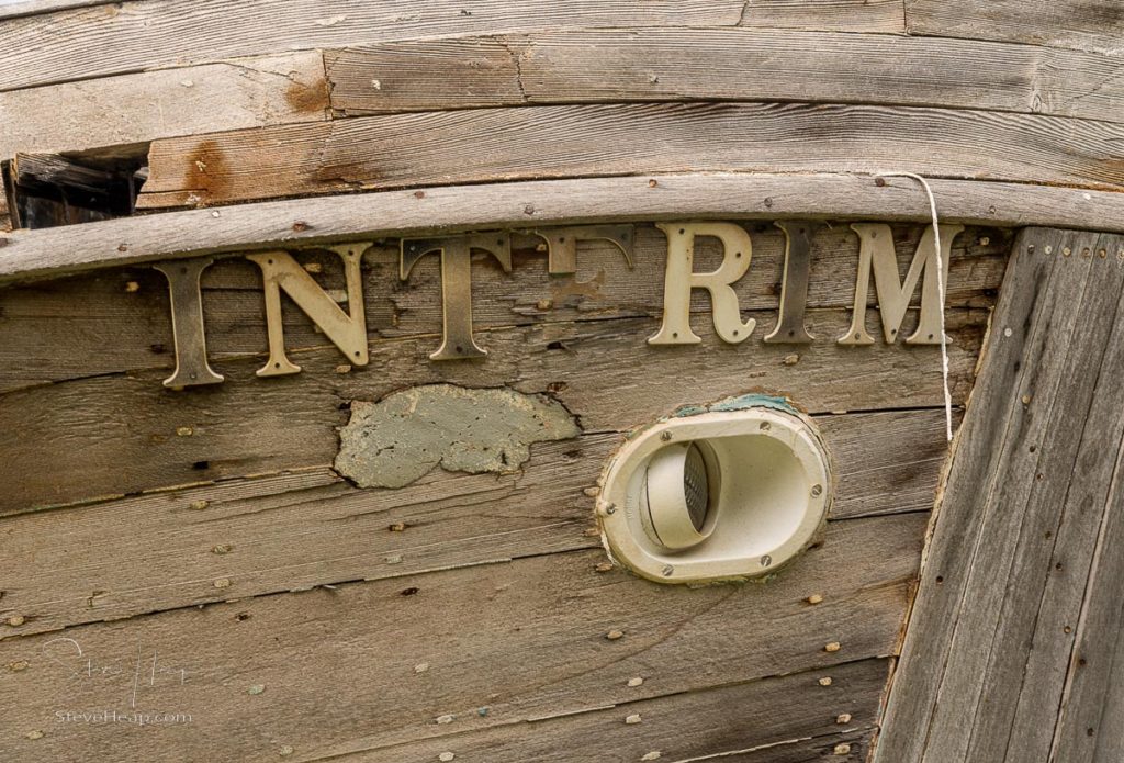 Hoonah, AK - 7 June 2022: Brass nameplate on small, abandoned fishing boat at Icy strait Point Alaska. Prints available in my online store