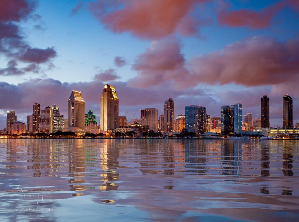 Skyline cityscape of San Diego downtown skyscrapers at night with lights reflecting into a digital ocean. Prints available in my online store