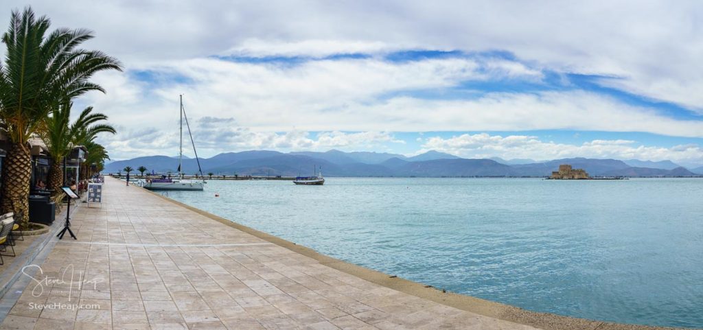 NAFPLIO, GREECE - 15 MAY 2019: Promenade and harbour with the old venetian castle of Bourtzi in the harbor of Nafplio