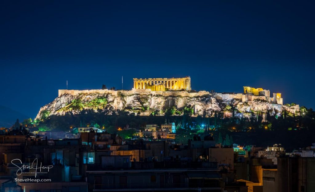 Acropolis hill at night with the city of Athens surrounding it