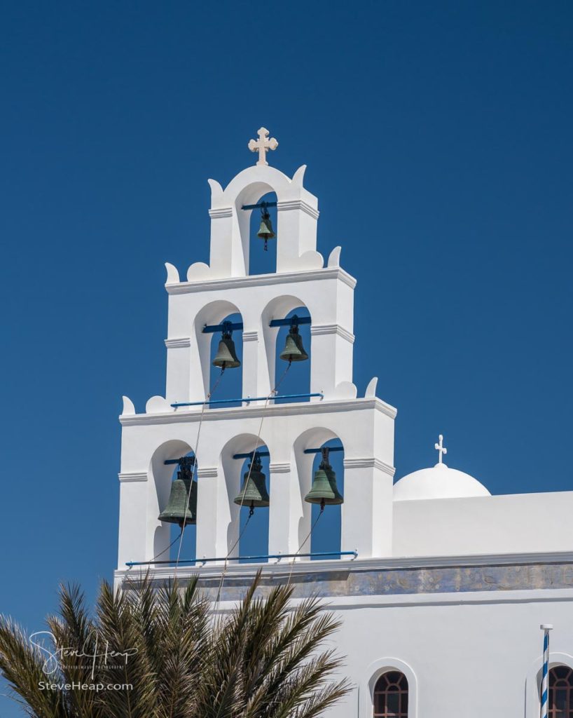 Traditional Greek Orthodox church with bell tower in village of Oia on Santorini