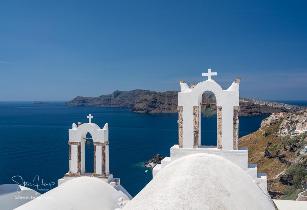 Traditional Greek Orthodox church with bell tower in village of Oia on Santorini