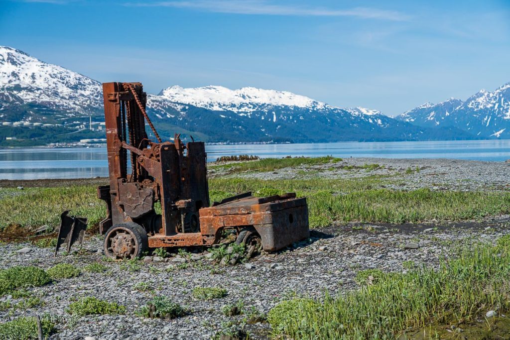 Remains of the old town destroyed in earthquake with rusty dock machinery on the coast