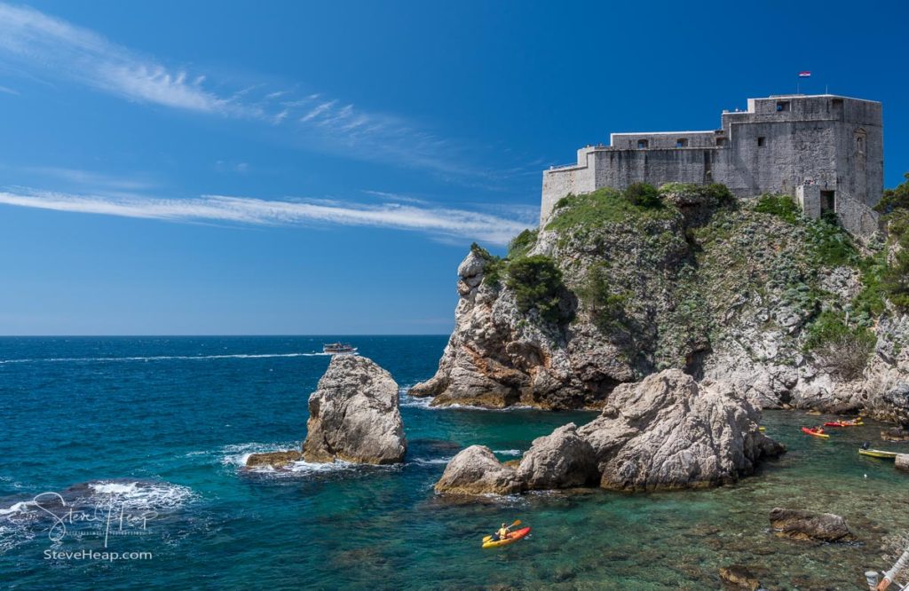 Kayakers or canoeists in the sea by the old fort Lawrence in Dubrovnik