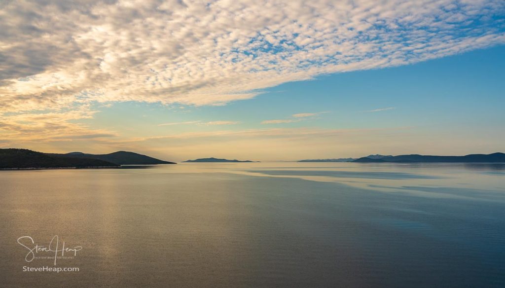 Calm Adriatic sea with islands off the coast of Croatia as ship approaches port of Zadar