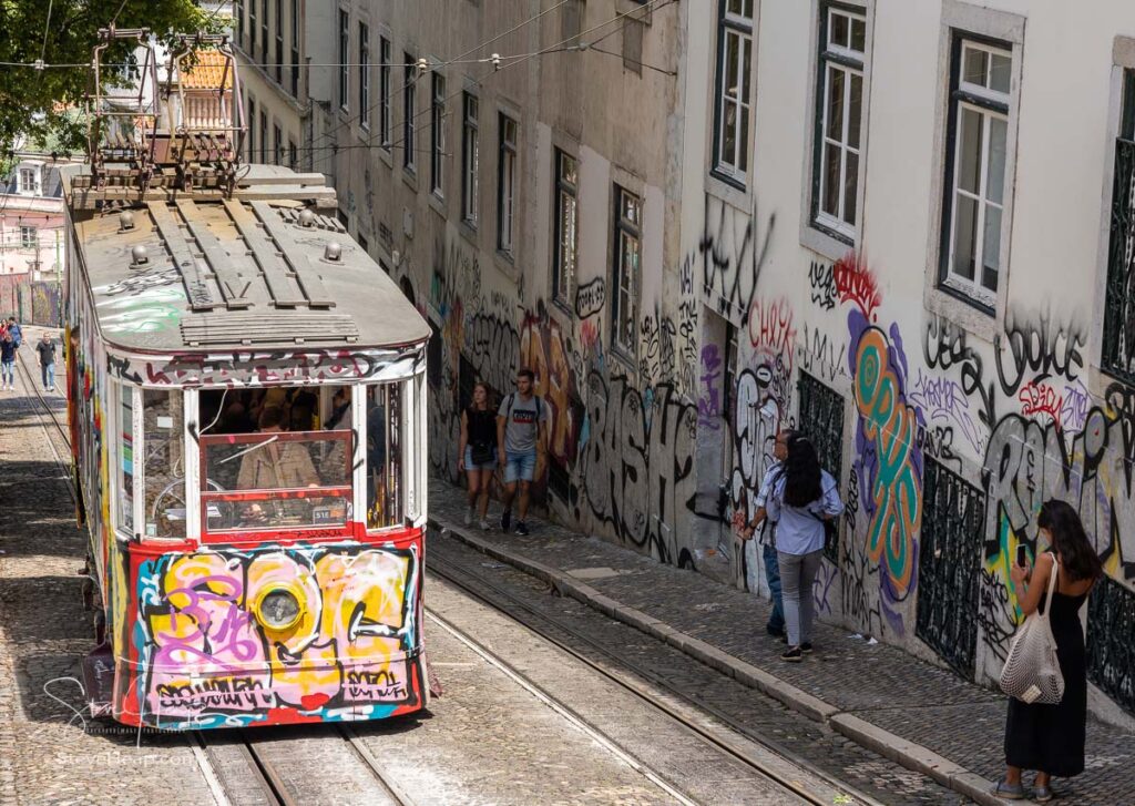 Ascensor da Gloria funicular railway with heavy graffiti painting