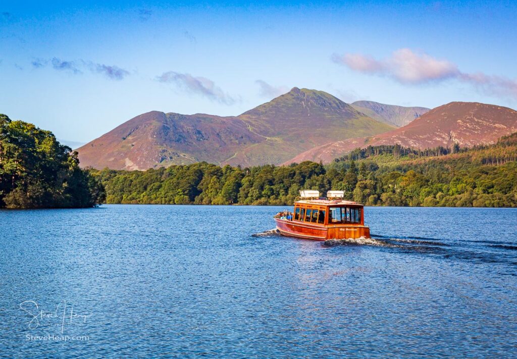 Antique Lady Derwentwater boat sailing with tourists on Derwentwater in English Lake District. Prints in my store