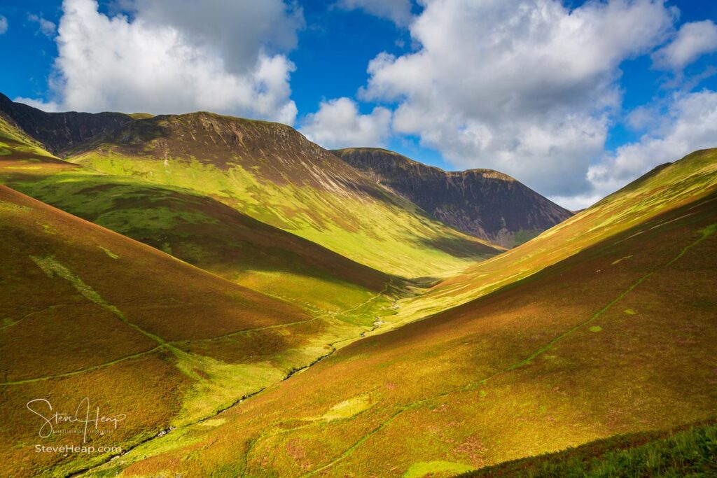 View over Newlands Valley from pass showing steep sided mountains and hills in English Lake District. Prints in my store