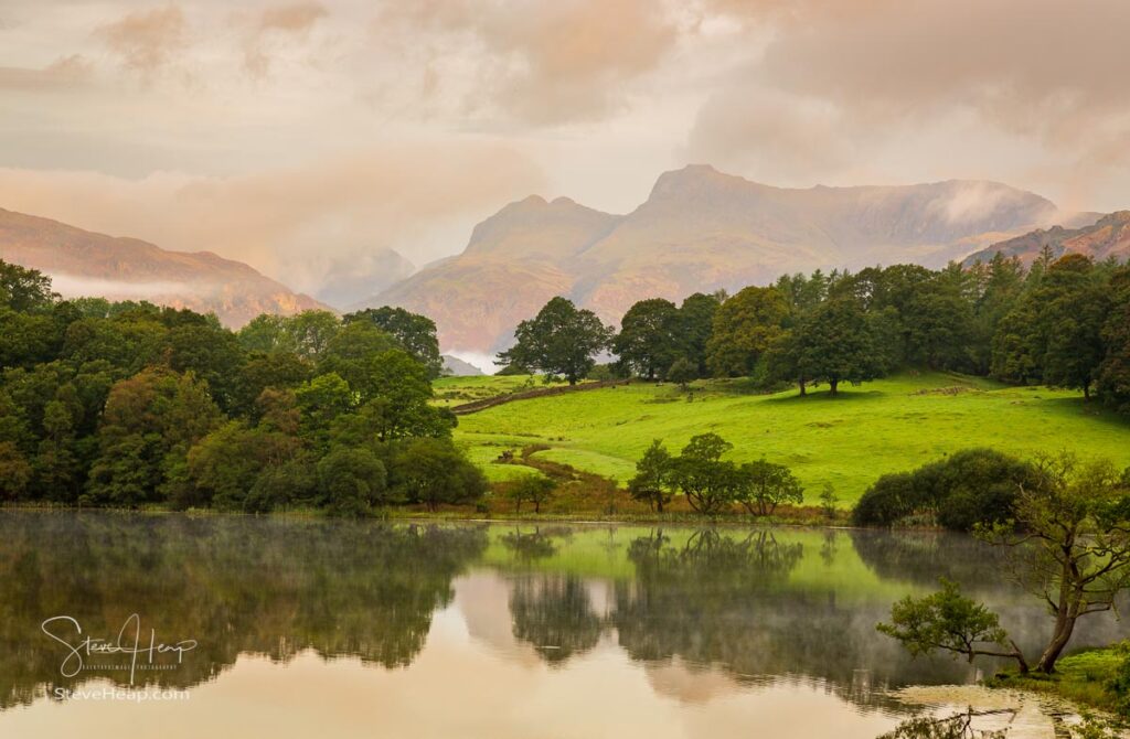 Sun rising and illuminating Langdale Pikes with Loughrigg Tarn in foreground. Prints in my store