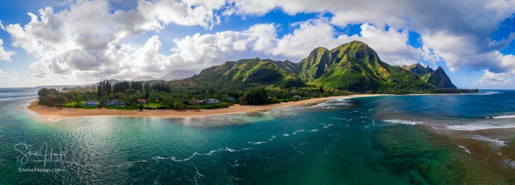 Aerial panoramic image off the coast over Tunnels beach on Hawaiian island of Kauai with Na Pali mountains behind. Prints available in my online store