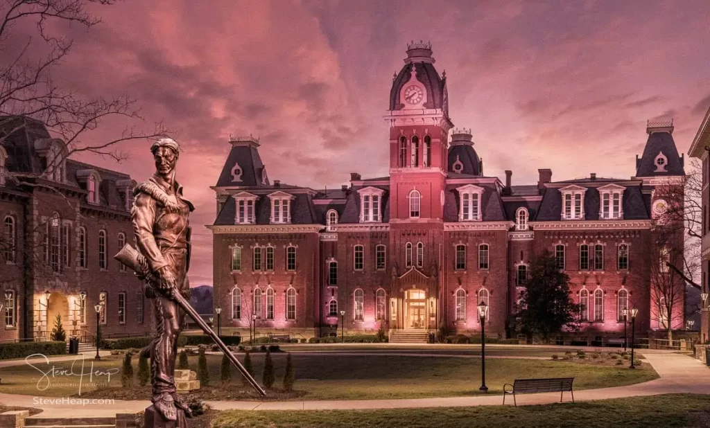 Mountaineer Statue standing proudly in front of Woodburn Hall in a sepia toned evening scene. Prints in my Etsy Store