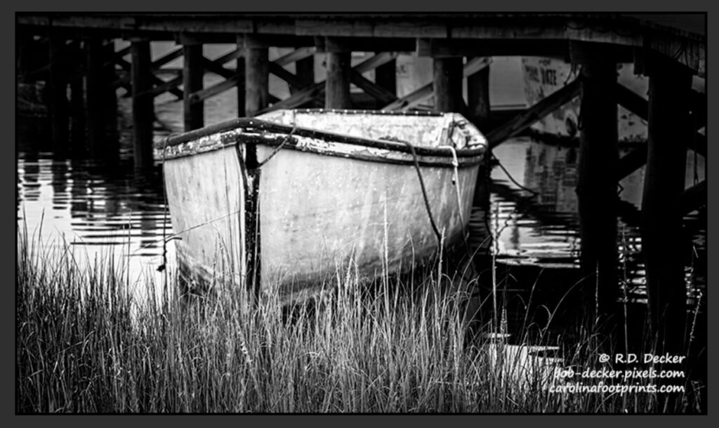 Black and White rowing boat moored by a pier in Carteret County, NC