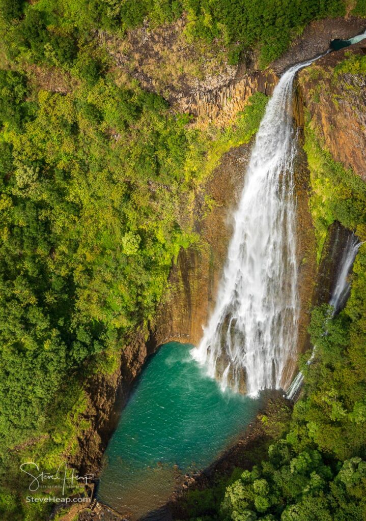 Aerial view of Manawaiopuna Falls and landscape of Hawaiian island of Kauai from helicopter flight. Prints available here