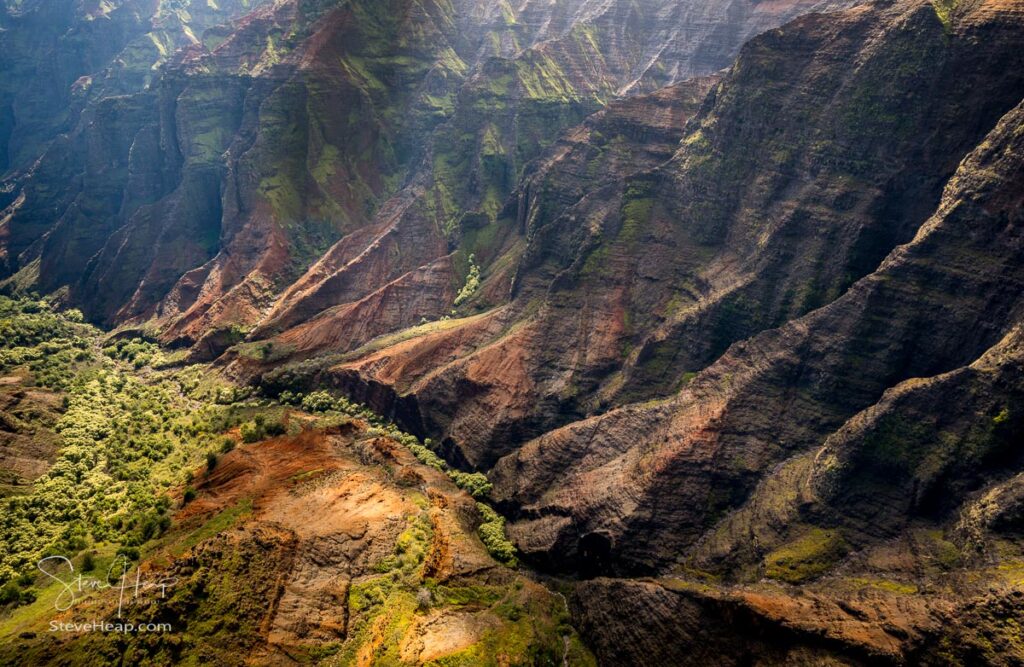 Aerial view of Waimea Canyon and landscape of Hawaiian island of Kauai from helicopter flight