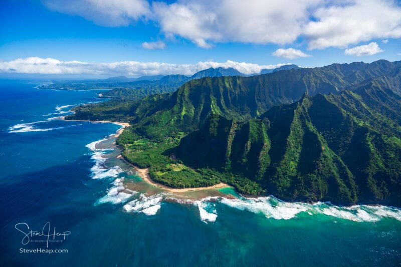 Aerial view of Ke'e beach and the coastline towatrds Hanalei on hawaiian island of Kauai from helicopter flight