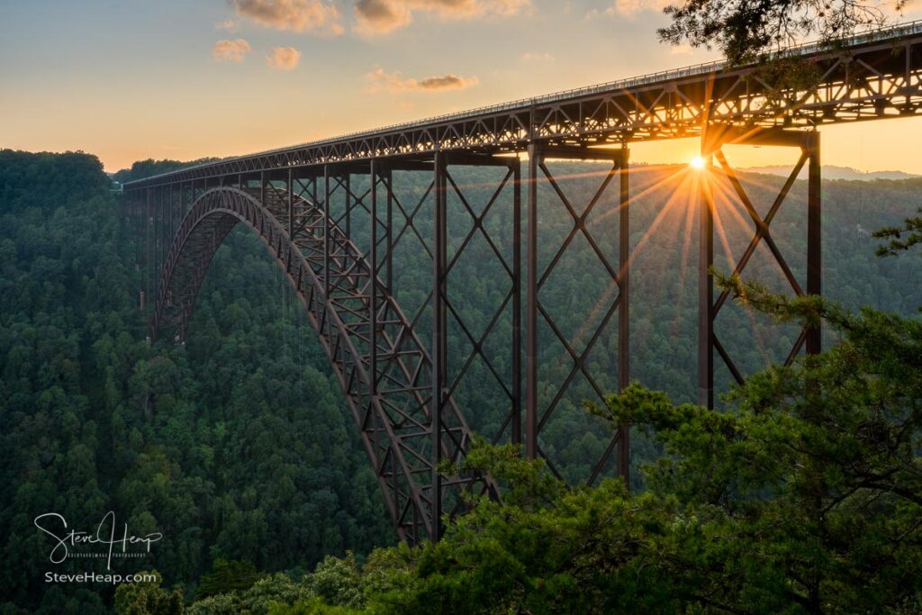 Setting sun behind the girders of the high arched New River Gorge bridge in West Virginia. Prints available in my online store