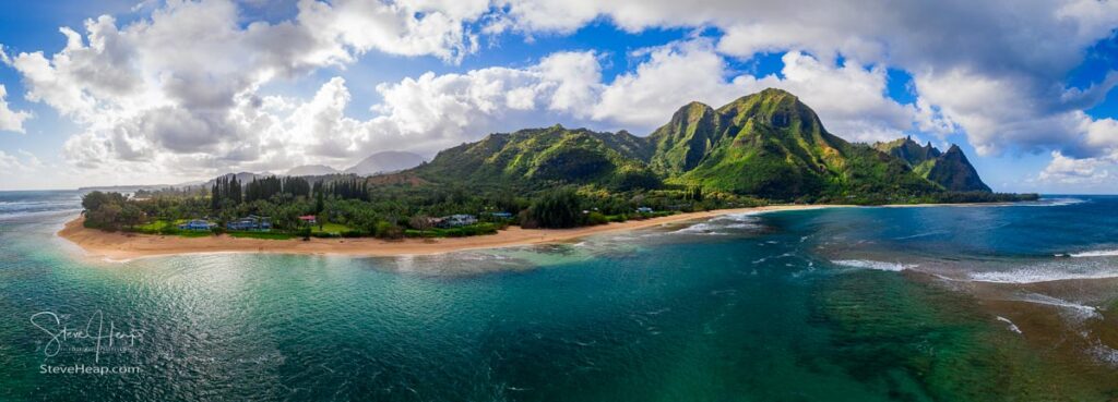 Aerial panoramic image off the coast over Tunnels beach on Hawaiian island of Kauai with Na Pali mountains behind. Prints available here