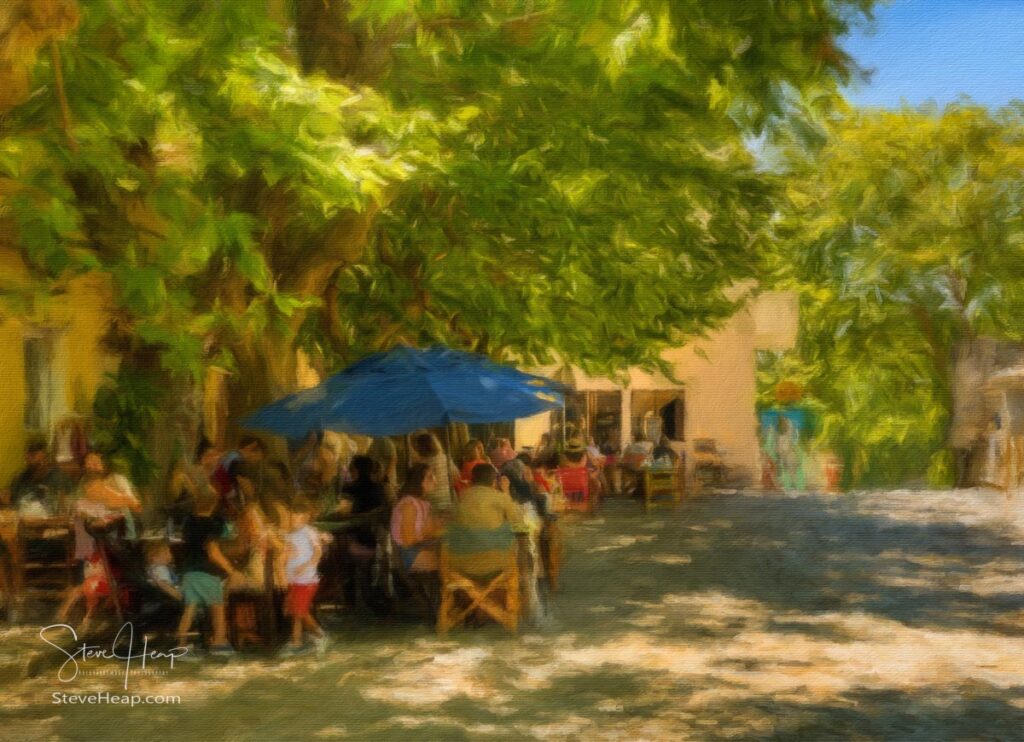 Local people enjoying a lunch in the shade of the trees by the main square