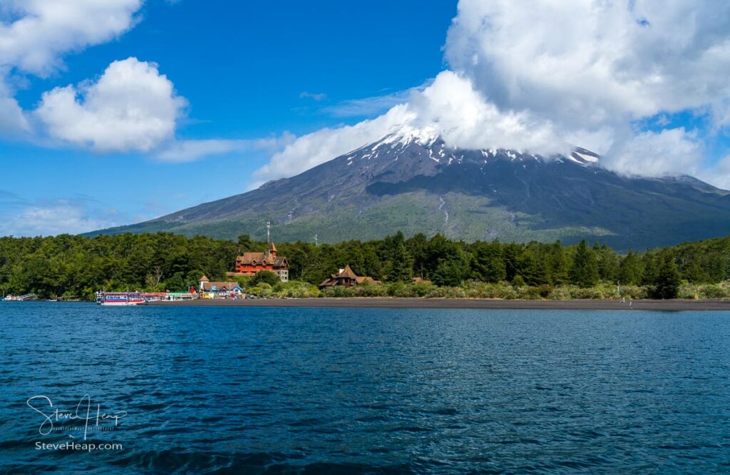 Boats docked at Petrohue harbor on the Todos Los Santos lake in Chile with the Osorno volcano in the background
