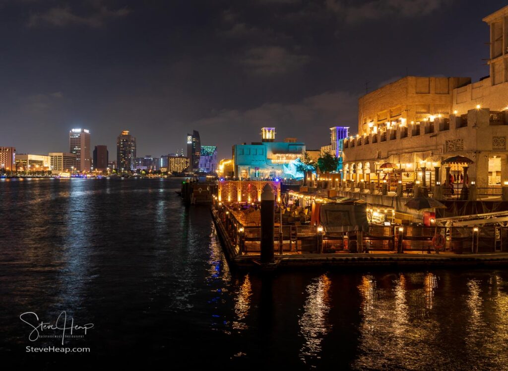 Dubai, UAE - 30 March 2023: View down the Creek towards Deira with waterfront restaurants