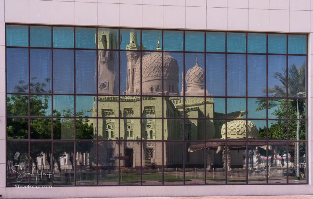 Distorted reflection of the exterior of the Jumeirah mosque in Dubai, UAE in the windows of an office building. Prints in my store