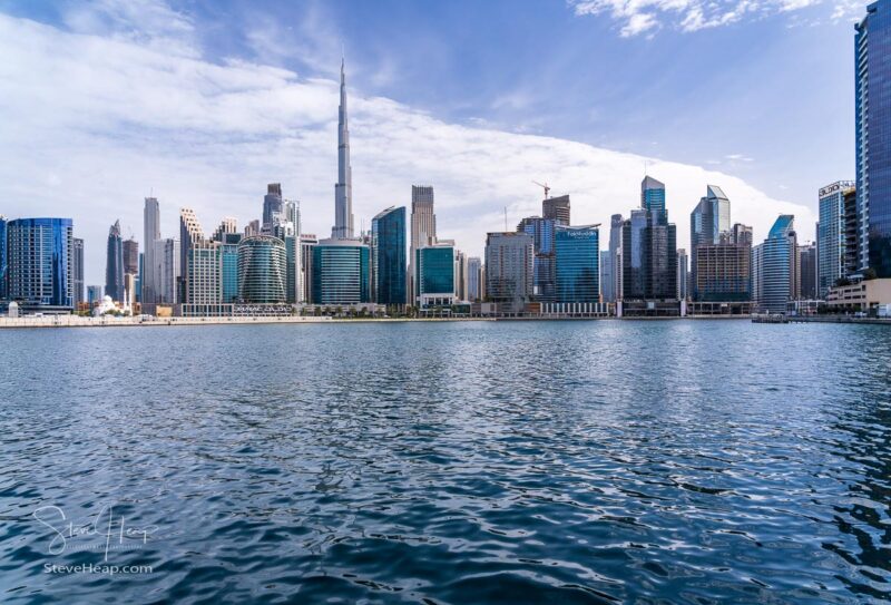 Dubai, UAE - April 2, 2023: Skyline of downtown district from water level in Business Bay