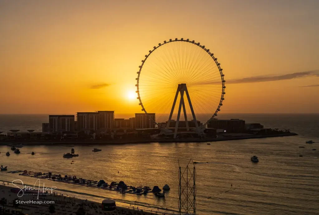 The sun starts to set behind the Ain Dubai Observation Wheel on Bluewater Island seen from JBR Beach
