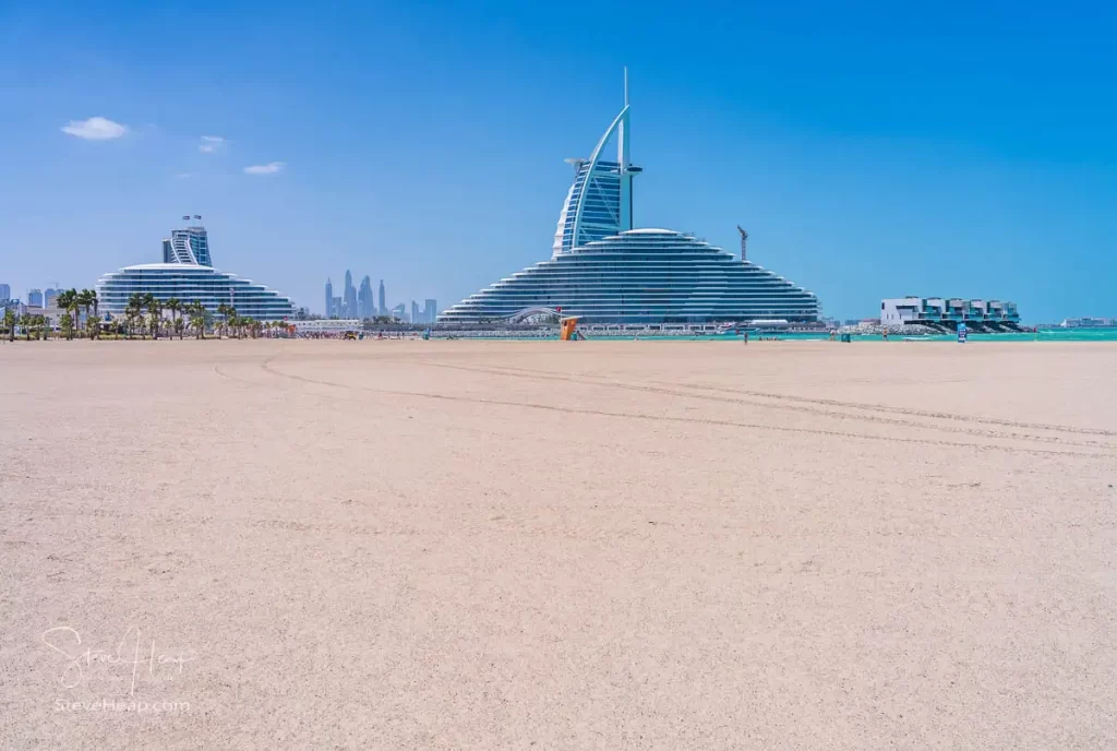 Large open beach looking back to the Marsa Al Arab and Burj Al Arab hotels in Dubai