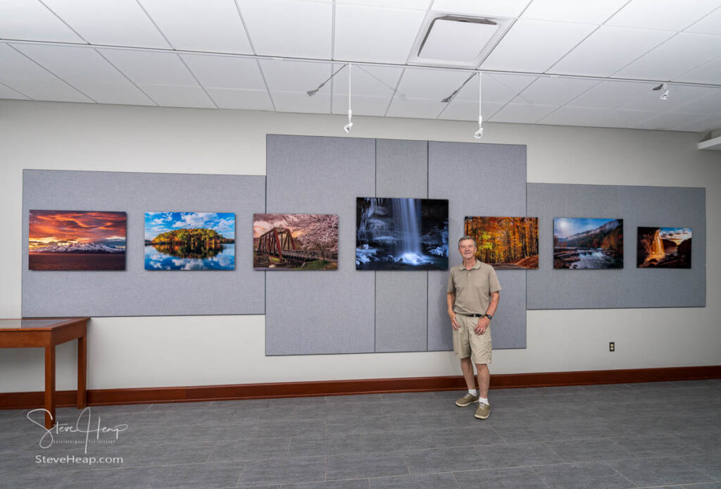 The artist and his work! Taken just after I finished hanging the acrylic prints. Steve Heap in the Nutting Gallery at WVU Alumni center