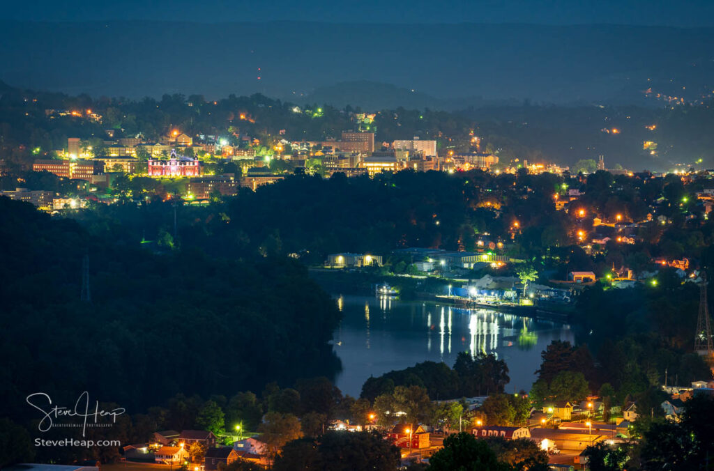 The lights sparkling over the city of Morgantown in West Virginia with the river reflecting lights in the foreground. Prints available here