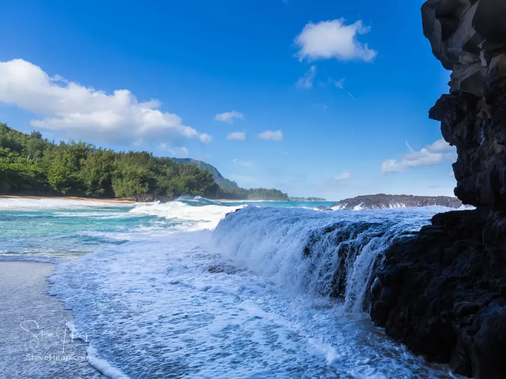 Waves flowing over the rock platform - and look at some of those further along the beach!