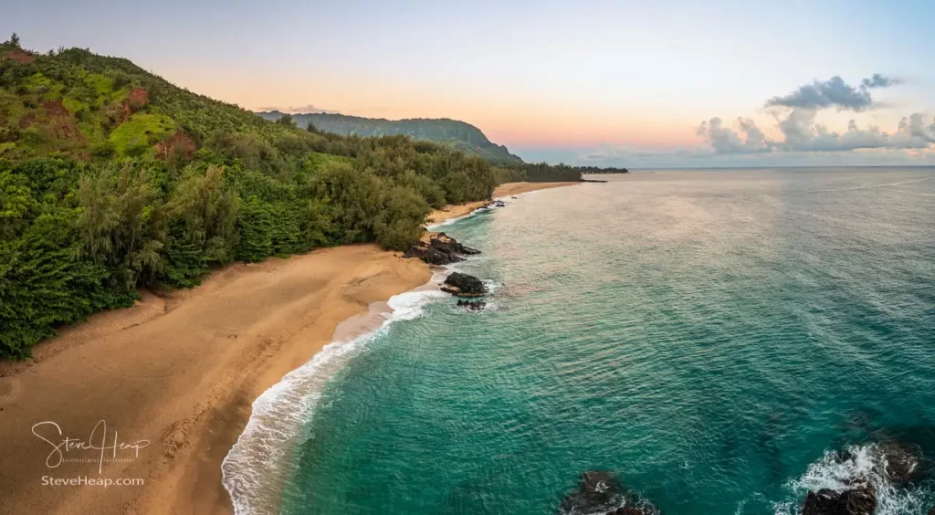 Sunrise looking down the length of Lumahai beach showing the full extent of the view towards Tunnels Beach and beyond. Prints available here