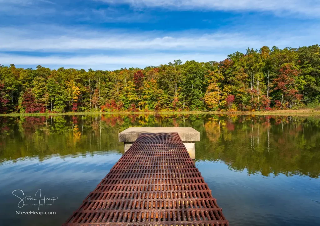 Iron walkway to the concrete platform in Coopers Rock state forest reservoir with fall colors behind. Prints can be purchased here in my store