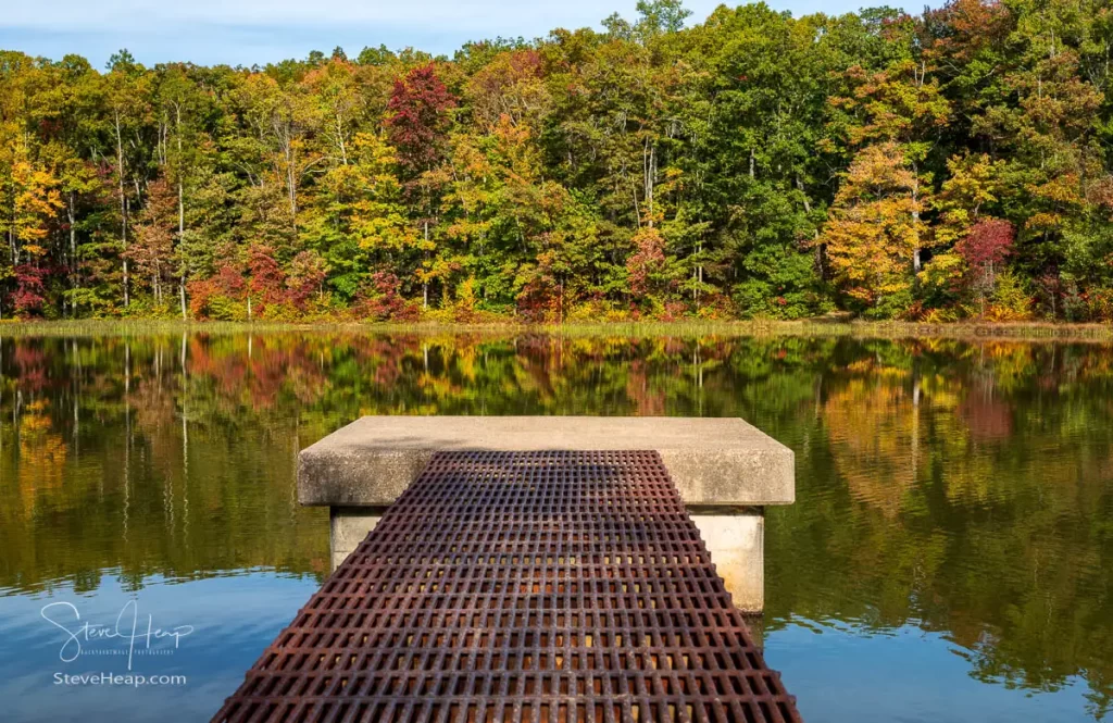 Closer view of the iron walkway and pier with the concrete platform with the fall colors of the trees reflecting in the calm waters. Prints available here.