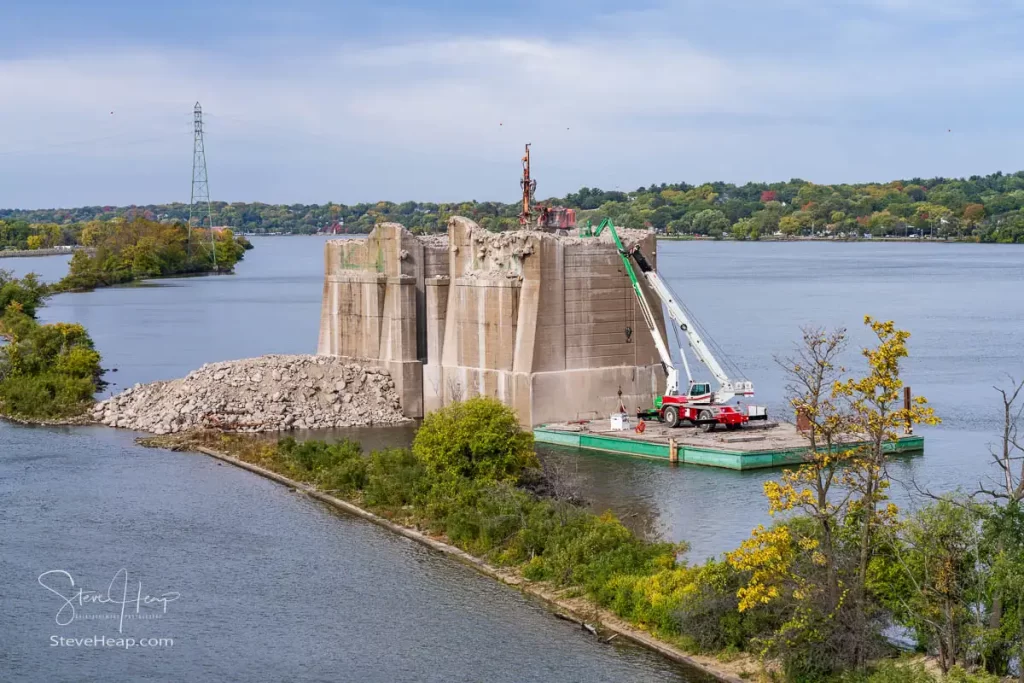 Heavy machinery removes the concrete pillars of historic I-74 bridge between Bettendorf Iowa and Moline Illinois