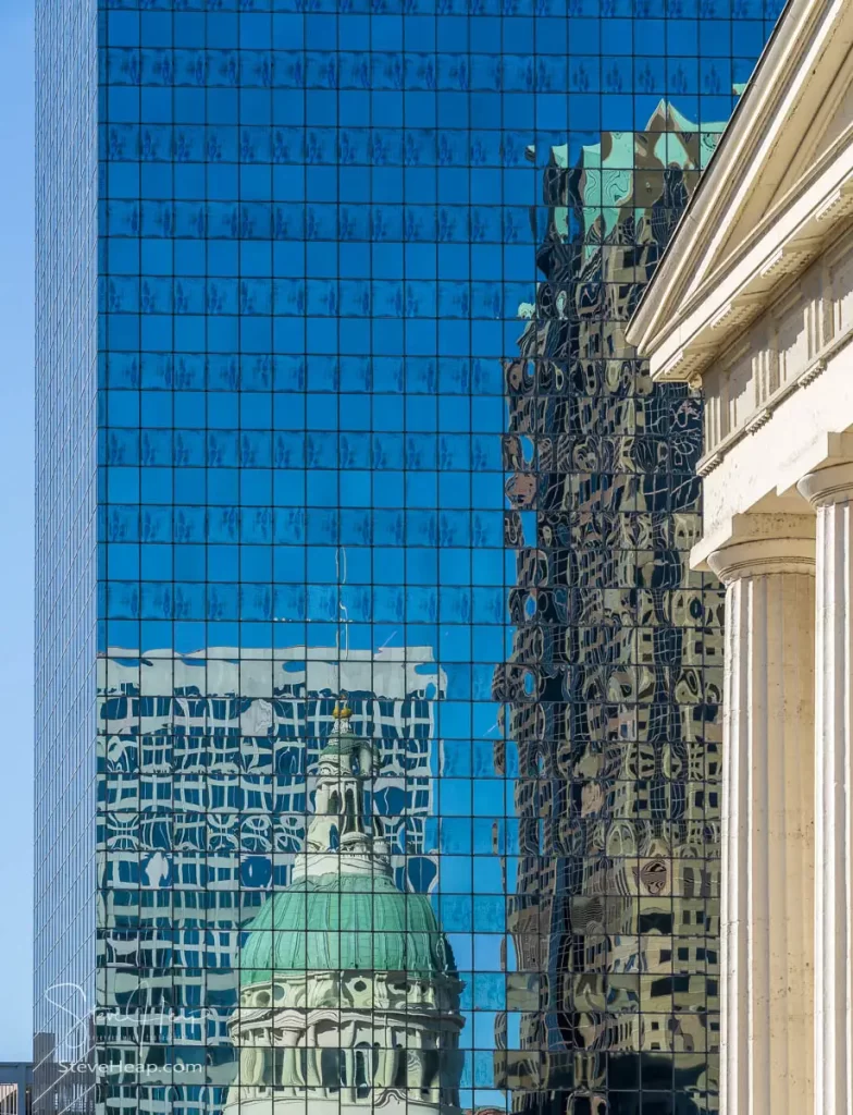 The dome of the old Courthouse in St Louis, Missouri in a mirrored glass covered skyscraper in the next street
