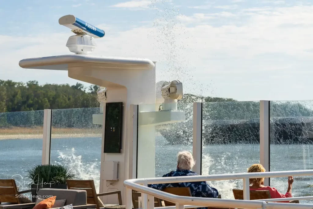 Wash from the passage of a large barge providing an unwelcome shower for some guests