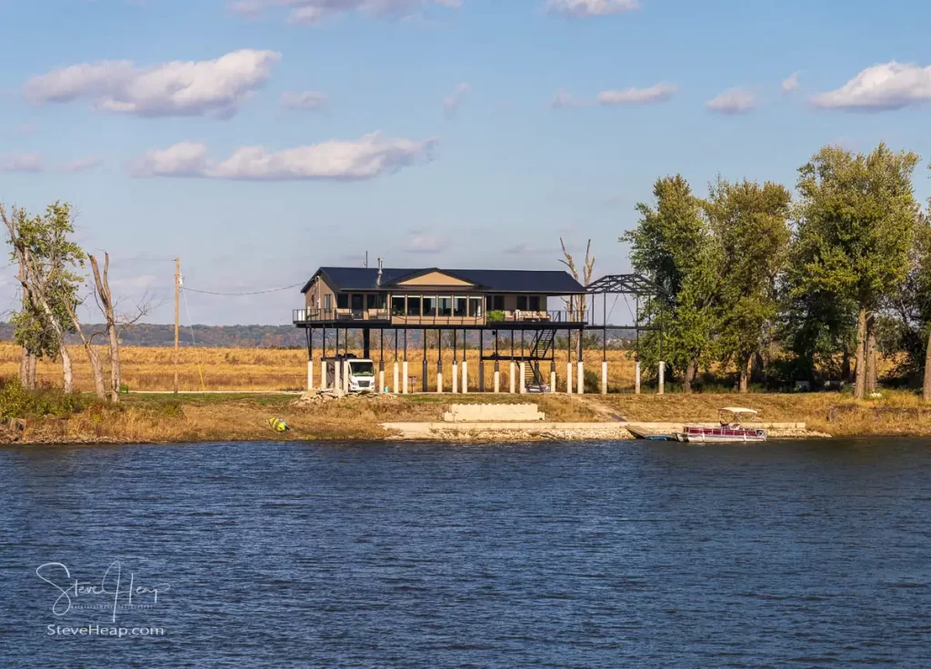 Home standing on massive stilts and concrete posts to rise above the floods of the Mississippi River