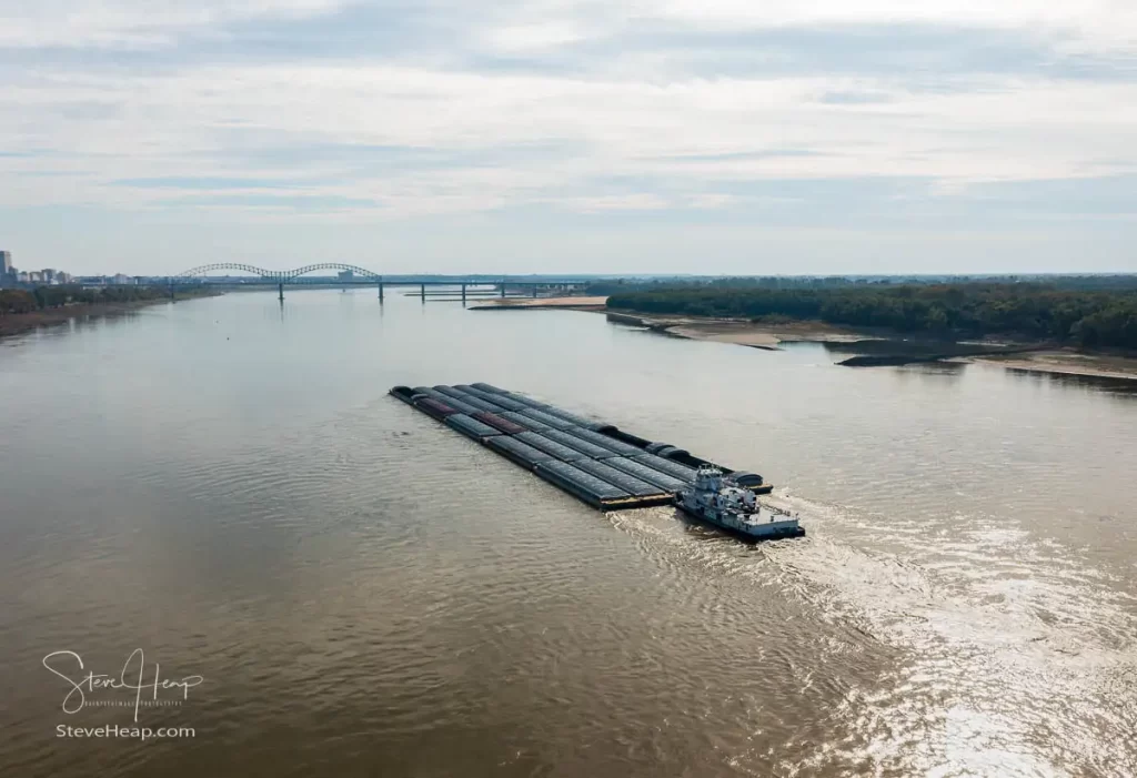 Large barge sailing down the Mississippi River towards Memphis