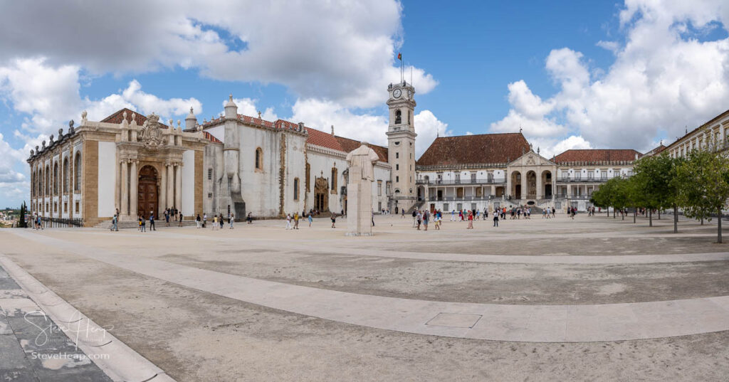 Tourists visiting the Biblioteca Joanina of the University of Coimbra. The library is the building on the left with the clocktower central